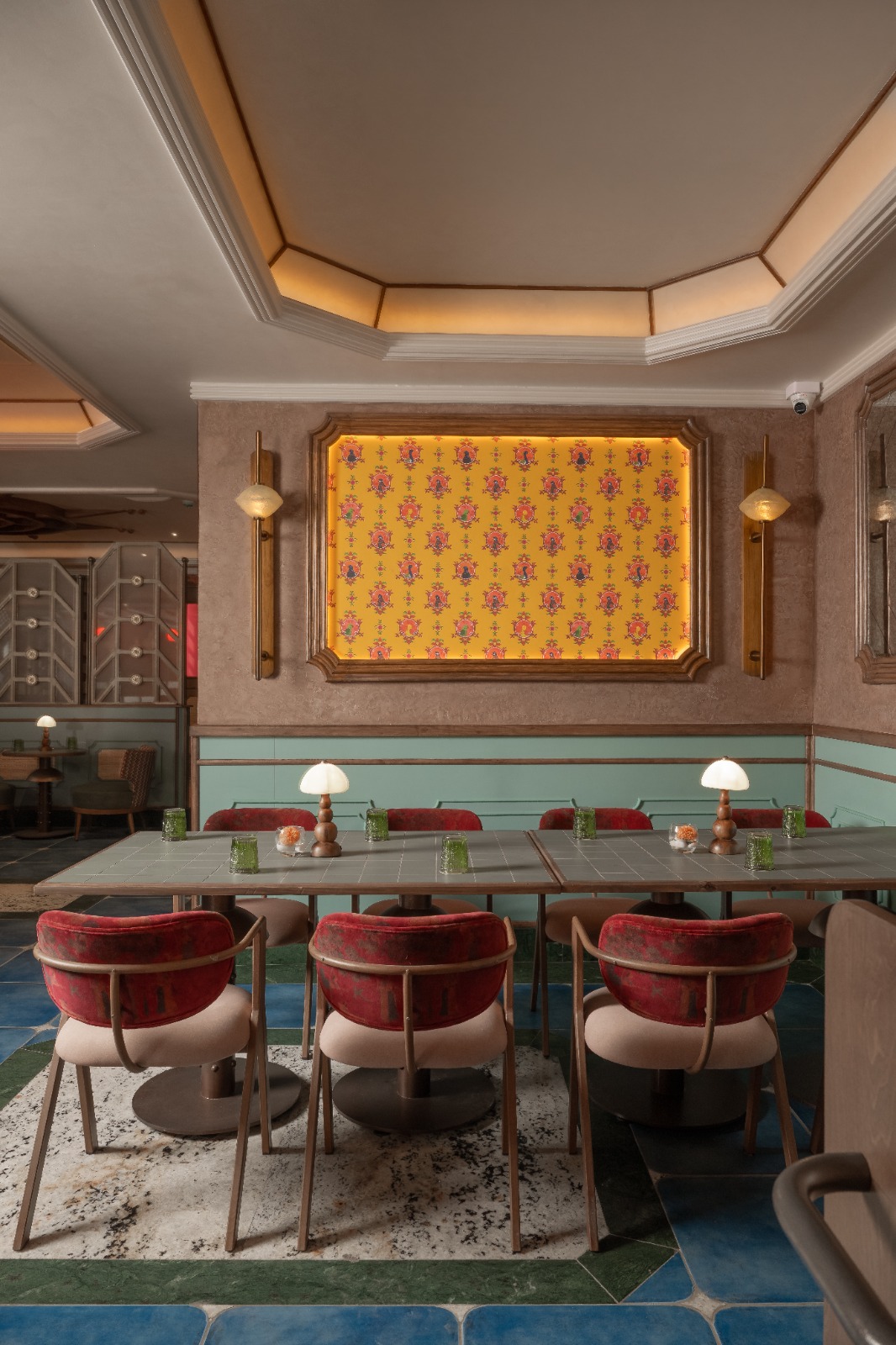 Dining table texture at Goonj — handcrafted tiles and botanical patterns
